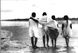 Gandhi walking with associates